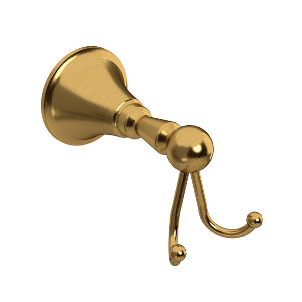 A shiny gold wall hook with a rounded base and a double hook.