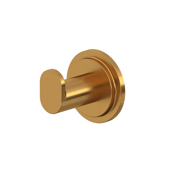 A gold-colored wall hook with a cylindrical design